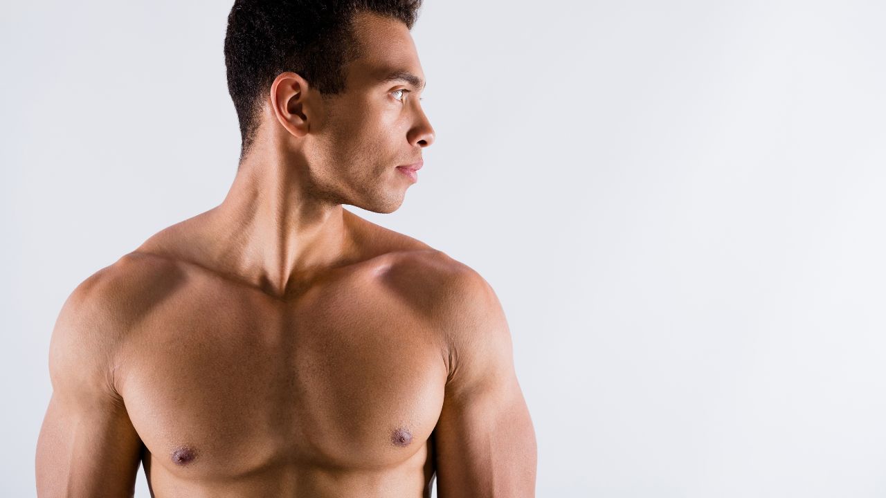 tanned guy looking aside working out